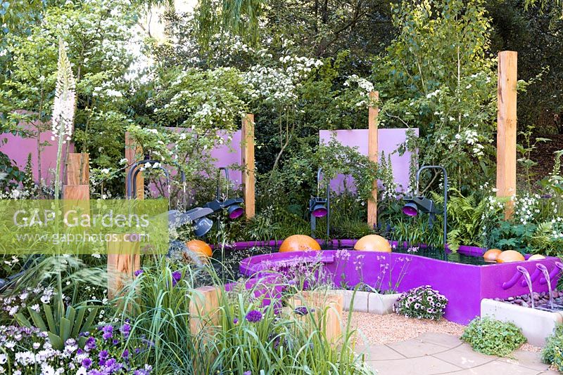 The Together We Can Garden. A contemporary garden inspired by sound, featuring a water marimba with york stone spheres. Sponsor: Papworth Trust. Designer: Peter Eustance. RHS Chelsea Flower Show 2016