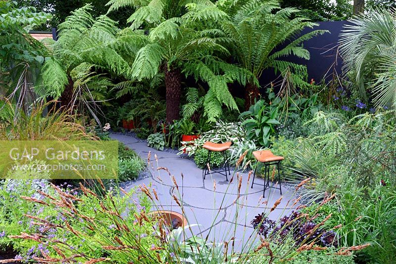 Garden For Crohns Disease. Hardy Exotics planting. Designers: Andrew Fisher Tomlin and Dan Bowyer. Sponsors: Bowel Disease UK. RHS Hampton Court Palace Flower Show 2016