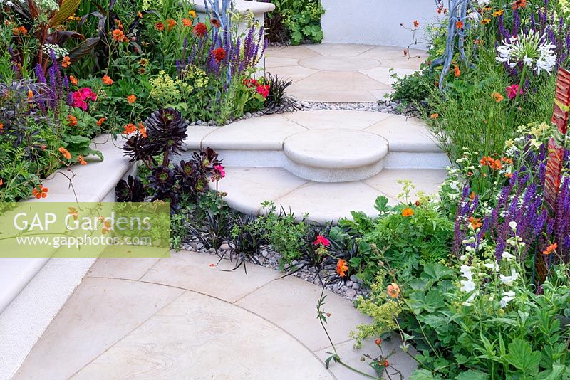 New Horizons City Garden. Stepped Patio with colourful Planting. Designers: Beautiful Borders Sponsors: Beautiful borders Garden Design. RHS Hampton Court Palace Flower Show 2016