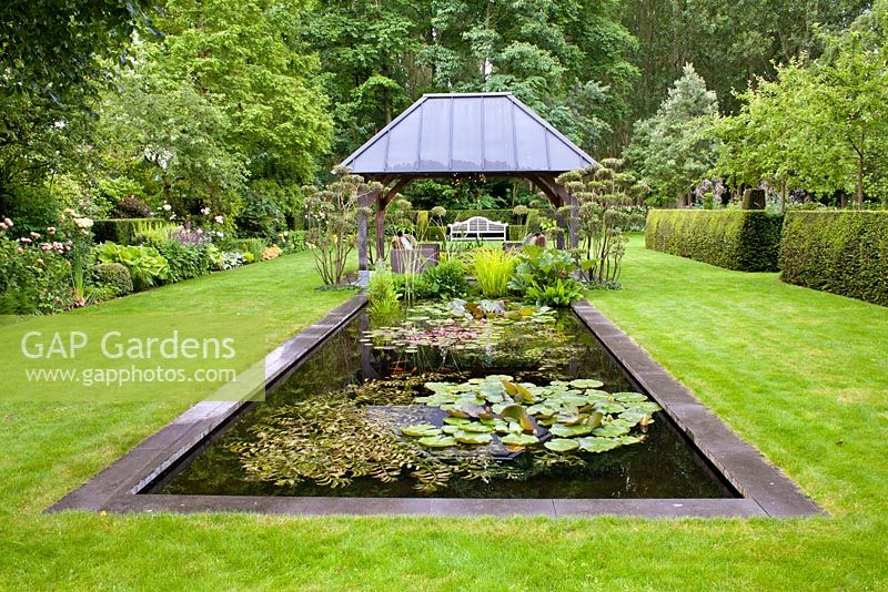 Rectangular pond with relaxing area under gazebo. Sarina Meijer garden.