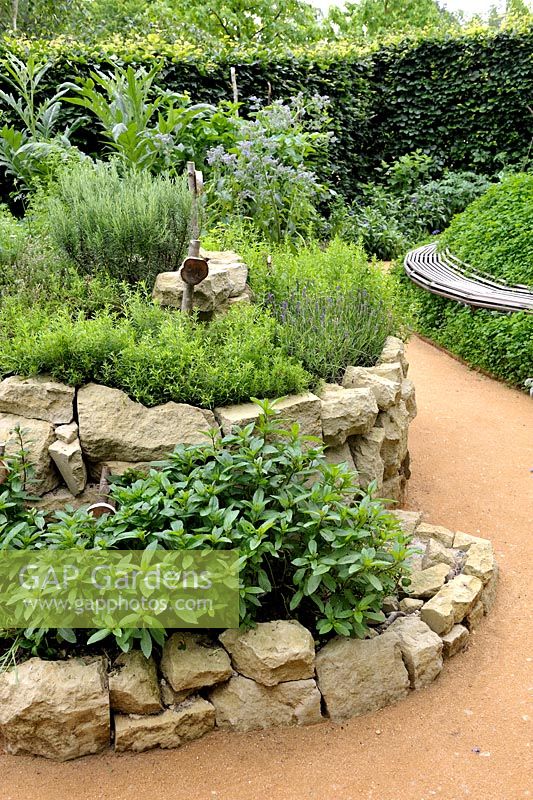 Herb spiral made of stones with Mentha x piperita, Satureja montana, Lavandula angustifolia and Rosmarinus officinalis'Le jardin qui se savoure' designed by Guillaume Popineau, David Trigolet and Chantal Dufour at the Festival International des Jardins 2016, Chaumont-sur-Loire, France