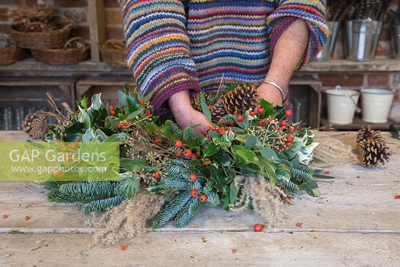 Adding Pine cones to the traditional christmas wreath
