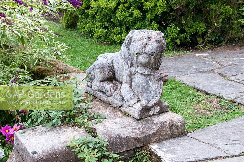 Stone lion statue in the Gardens of Ilnacullin - Garinish Island. Glengarriff, West Cork, Ireland. The Gardens are the result of the creative partnership of Annan Bryce and Harold Peto, architect and garden designer. August