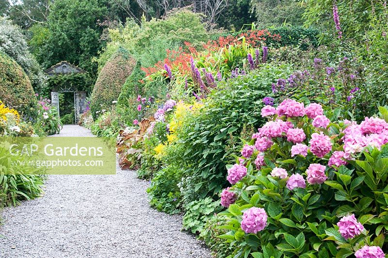 The Walled garden with herbaceous borders in the Gardens of Ilnacullin - Garinish Island. Glengarriff, West Cork, Ireland. The Gardens are the result of the creative partnership of Annan Bryce and Harold Peto, architect and garden designer. August