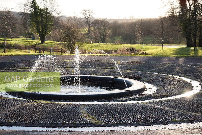 Circular pond with water jets at the National Botanic Garden of Wales in December