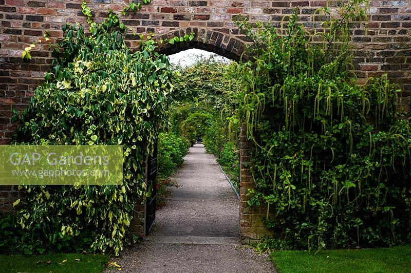 Gateway in brick wall leading to walled garden, Arley Hall Gardens, Cheshire