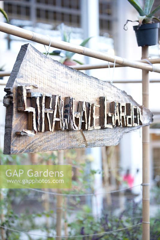 Signboard with wooden letters Strawbale Garden.