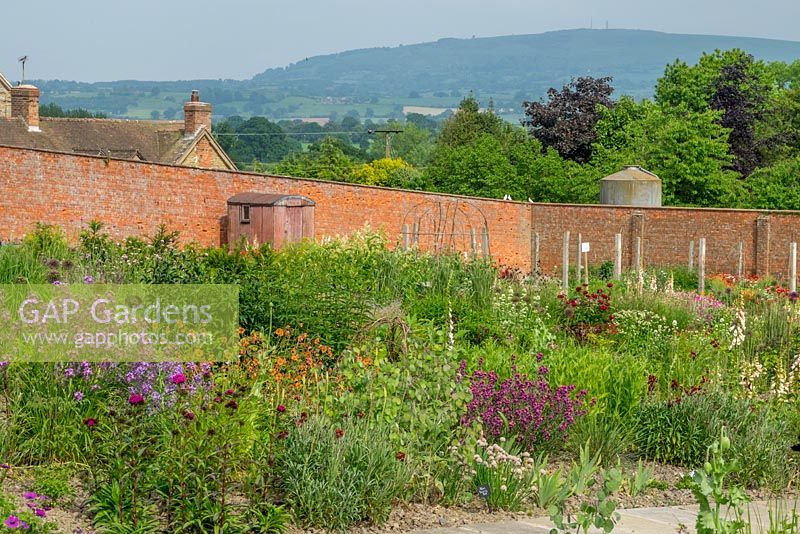 View looking over the walled garden with the shepherds hut to the distant hills.