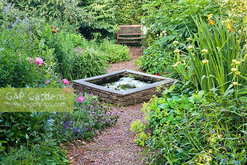 Secluded corner with garden bench and borders