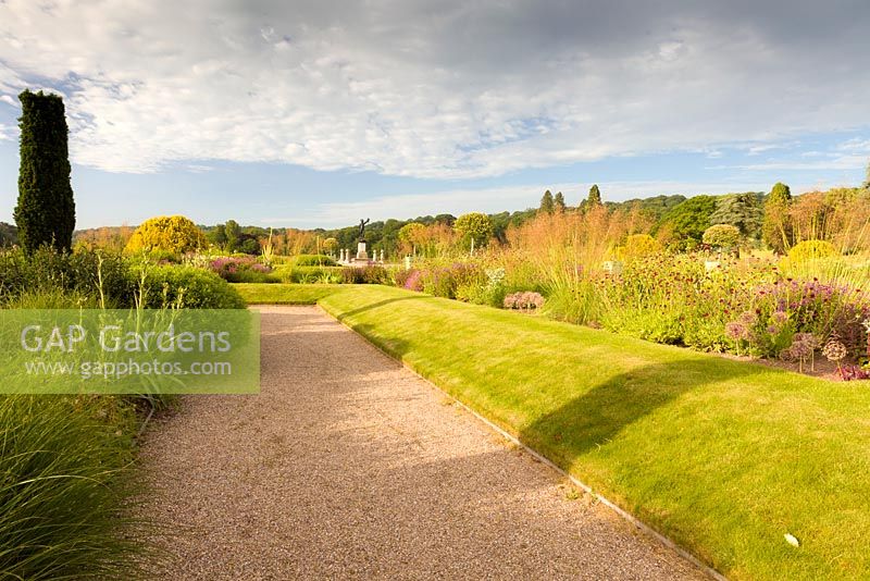 The Italian Garden at Trentham Gardens, Staffordshire - designed by Tom Stuart-Smith. Planting includes fastigate Irish yews, Geraniums, Knautia macedonica, Allium seedheads and Stipa gigantea