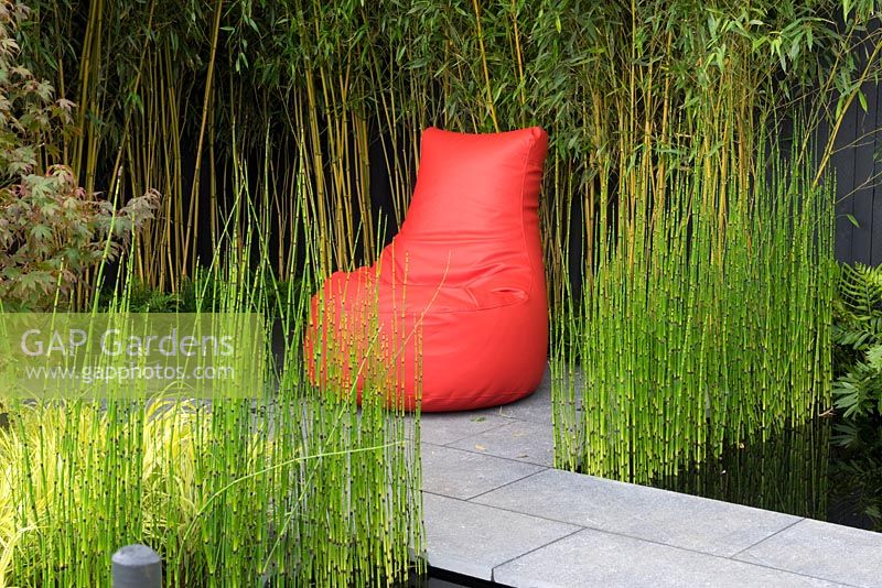Contempory red bean seat with Acer, Equisetum japonicum and bamboo