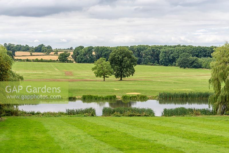 A view of the River Ise and the Northamptonshire countryside from the gardens at Kelmarsh Hall