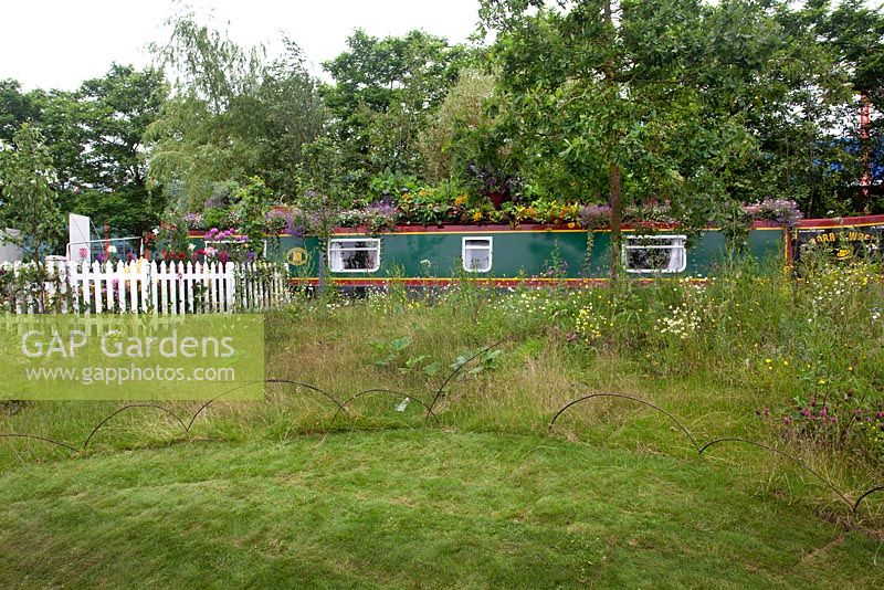 View of the canal boat and the wildflower meadow in The Canal Boat Garden, BBC Gardener's World Live 2016