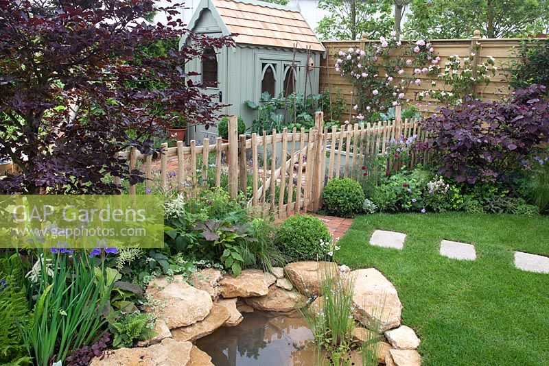 View of pond, through to vegetable garden and Summer House in the Urban Nature Garden at BBC Gardeners World Live 2016