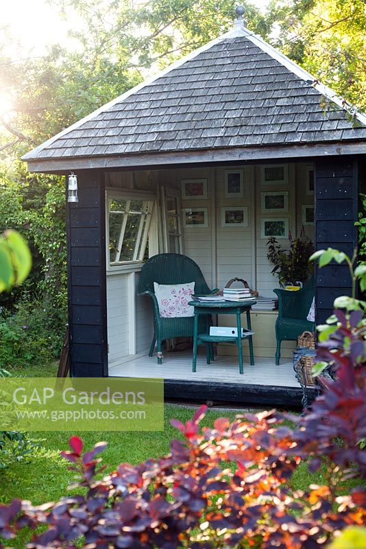 Secluded summerhouse in woodland garden. Garden: Rustling End Cottage, Hertfordshire. Owners: Mr and Mrs Wise