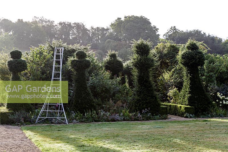 Pruning the yew topiary at Hanham Court Gardens in late summer.