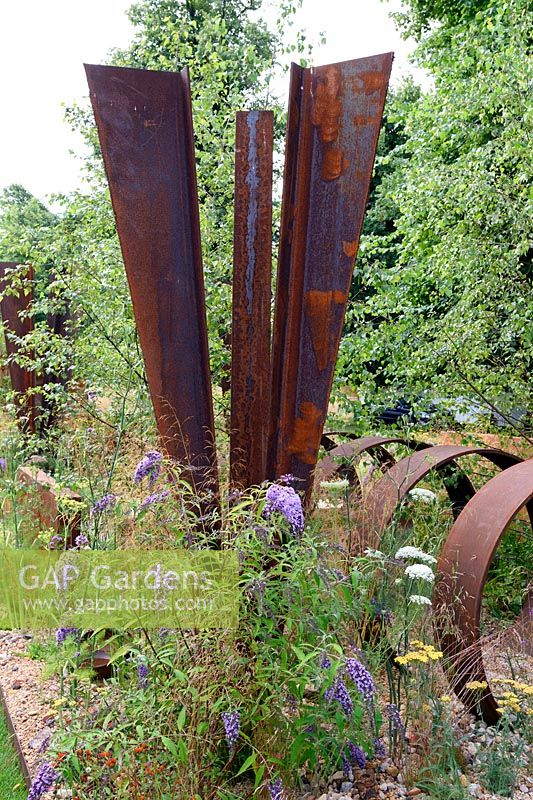 Brownfield - Metamorposis. Rusted steel structures in gravel garden. Design: Martyn Wilson Sponsors: St. Modwen. RHS Hampton Court Palace Flower Show 2017