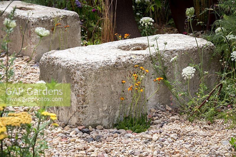 Hampton Court Flower Show, 2017. Brownfield Metamorphosis Garden, des. Martyn Wilson. Concrete seating bench in gravel garden