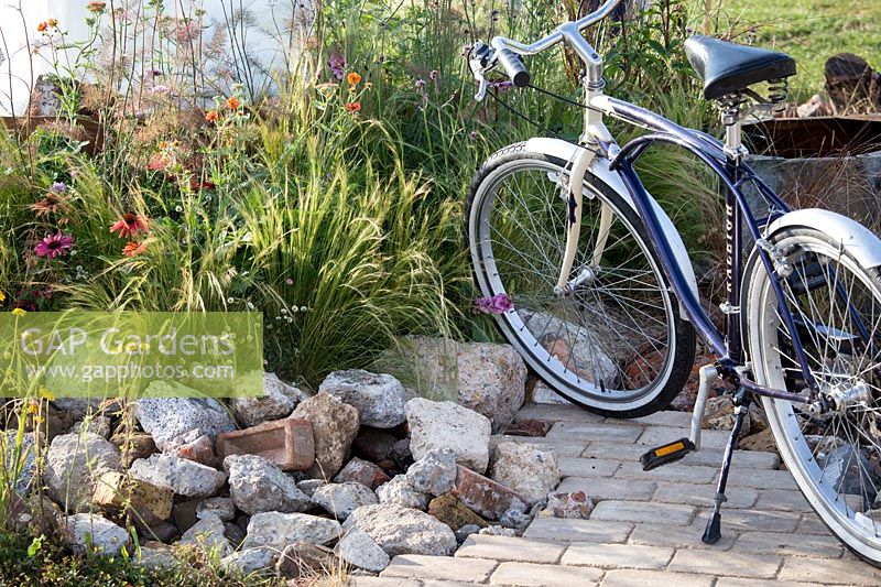 Hampton Court Flower Show, 2017. The Power to Make a Difference Garden. Bicycle in garden