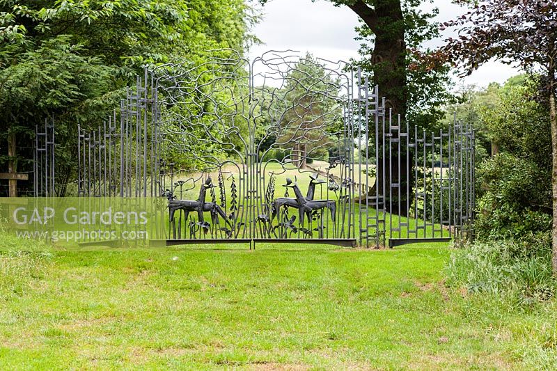 Ornamental metal gate by Richard Bent, Farleigh House, Farleigh Wallop, Hampshire. June. Designer Georgina Langton. 