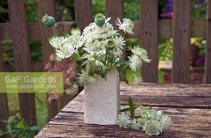 Astrantia major 'Shaggy', Daucus dara and poppy seedheads in floral arrangement