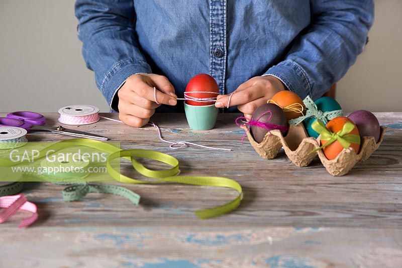 Decorating dyed easter eggs with string