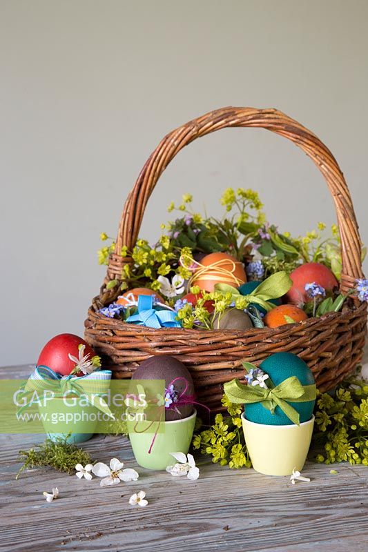 Decoarted dyed Easter eggs with ribbon, daintry flowers and string