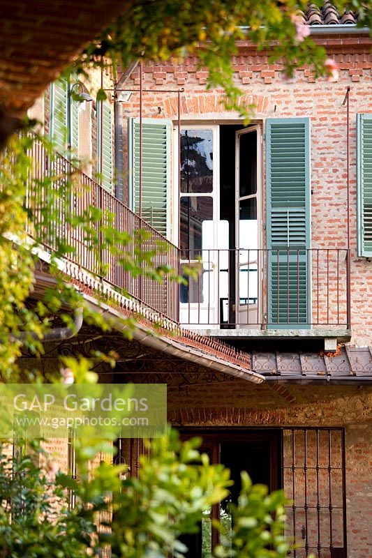 French doors on balcony. Govone. Garden project by Anna Regge. Piemonte, Italy.