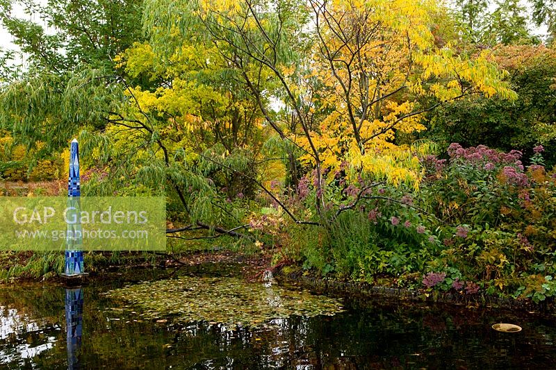 Pond with shrubs and trees. Rosendals Tratgard. Stockholm. Sweden