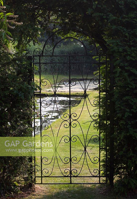 An old wrought iron gate leads to the moat.