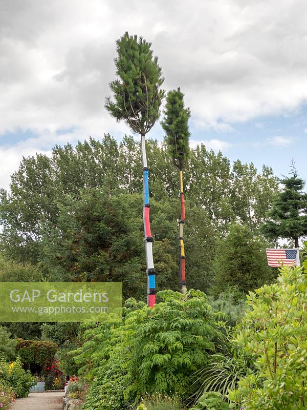 Trees with painted trunks to illustrate the geographic area in the World Garden, Lullingstone Castle, Eynsford, Kent