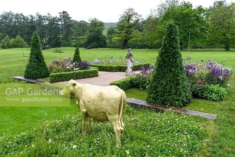 Formal clipped topiary and hand-painted golden Model Cow - Experience Peak District and Derbyshire Garden - RHS Chatsworth Flower Show 2017 - Designer: Lee Bestall MSGD - Builder: JPH Landscapes