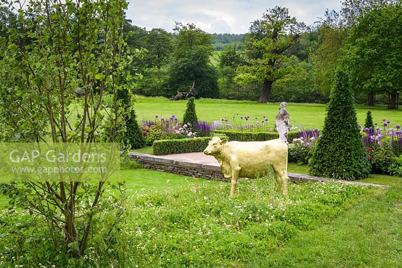 Formal clipped topiary and hand-painted golden Model Cow - Experience Peak District and Derbyshire Garden - RHS Chatsworth Flower Show 2017 - Designer: Lee Bestall MSGD - Builder: JPH Landscapes