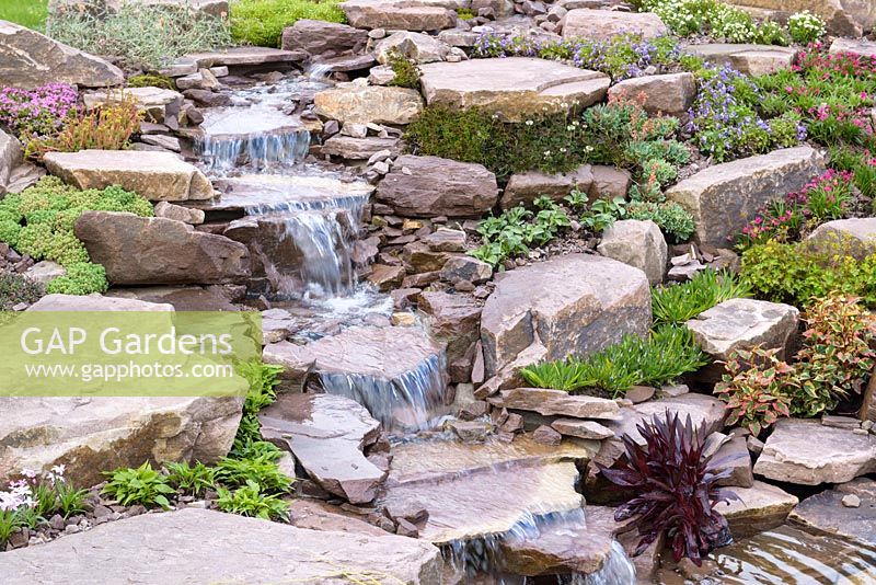 Waterfall. Naturalistic Water Garden - Jackie Knight's Just Add Water - RHS Chatsworth Flower Show 2017. Designer: Jackie Sutton - Built and sponsored by Jackie Knight Landscapes