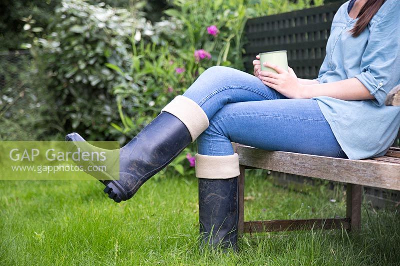 Woman relaxing on garden bench