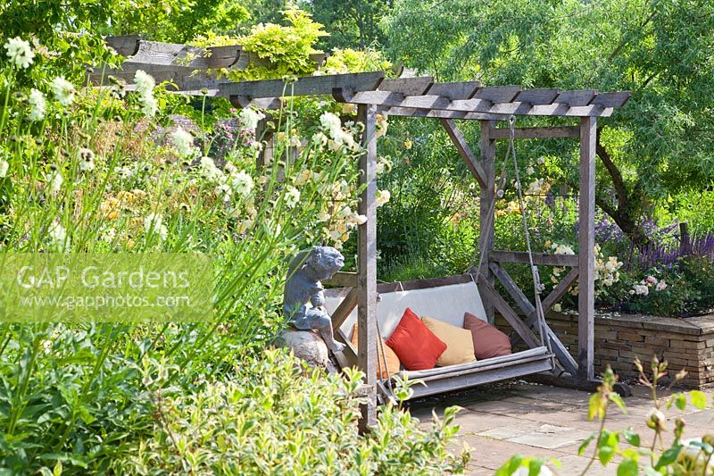 Wooden swing seat with Rosa, Salvia and Giant Scabious