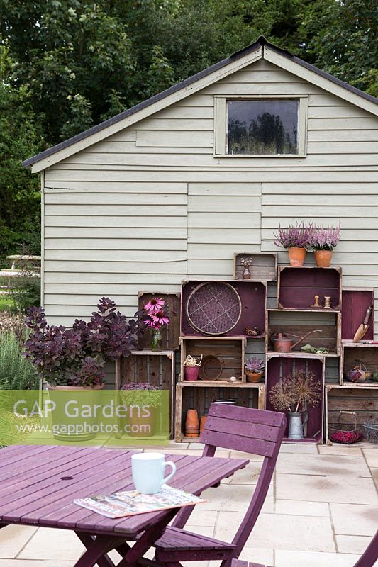 Vintage wooden crate storage with wooden garden table and chairs