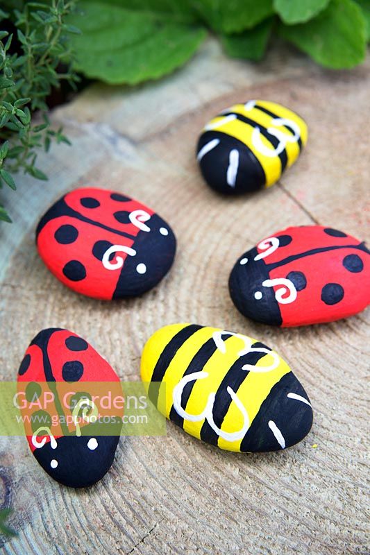 Garden craft making painted Bumble bees and Ladybirds with stones. Finished Ladybirds and Bumble bees