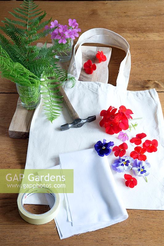 Printing onto fabric with fresh flowers. Materials needed - fabric, flowers and greenery, masking tape, a hammer and a board suitable for hammering on.