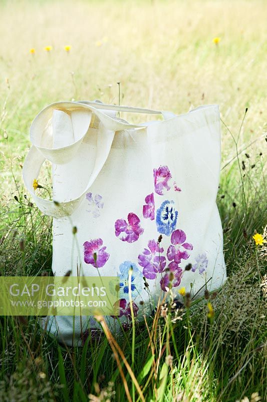 Printing onto fabric bag with fresh flowers. Finished printed bag