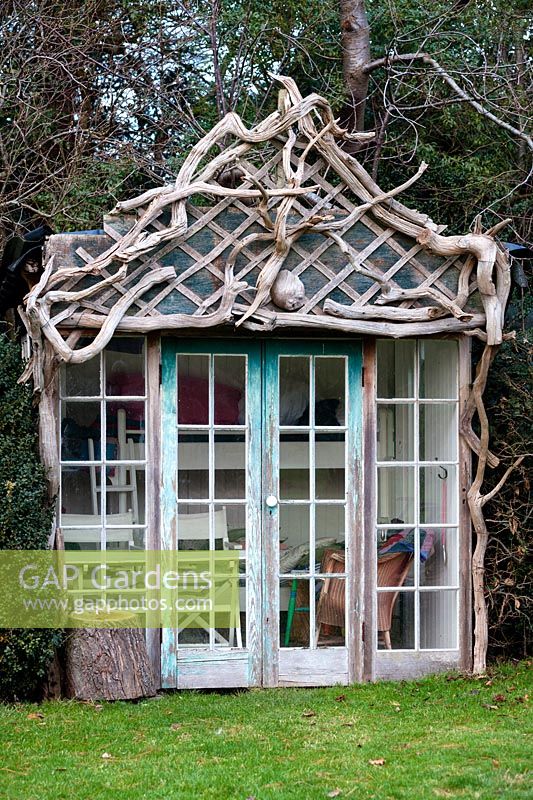 Driftwood summerhouse in Charlotte and Donald Molesworth's garden, Kent, UK.