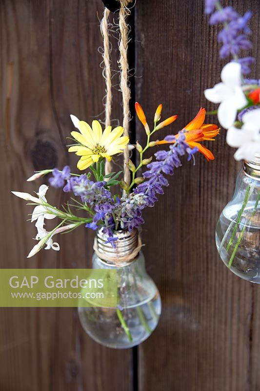 Home made hanging vase made from a lightbulb - hang two or more vases together for a pretty display