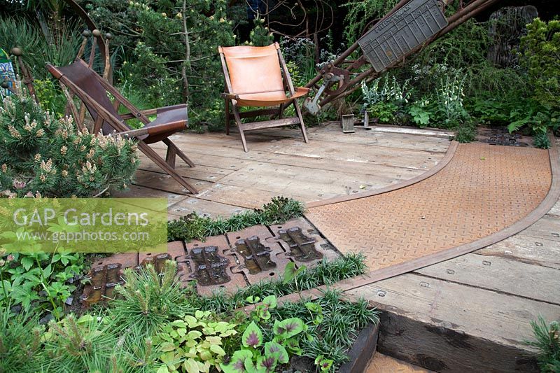 Walker's Wharf Garden supported by Doncaster Deaf Trust, view of industrial materials reused for paving and walling - RHS Chelsea Flower Show 2018