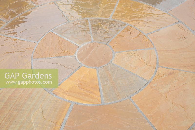 A wet circular patio with Buff Brown pavers