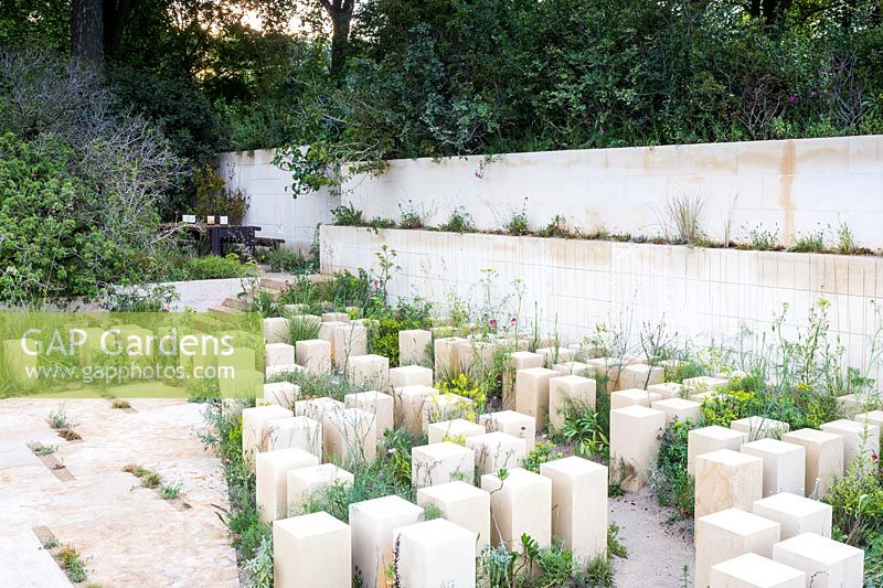 The M and G Garden, limestone blocks in a garden inspired by the Mediterranean landscape of Maalta. This part mimics the climate and diversity of the garrigue, and includes euphorbias, woad, valerian and grasses.