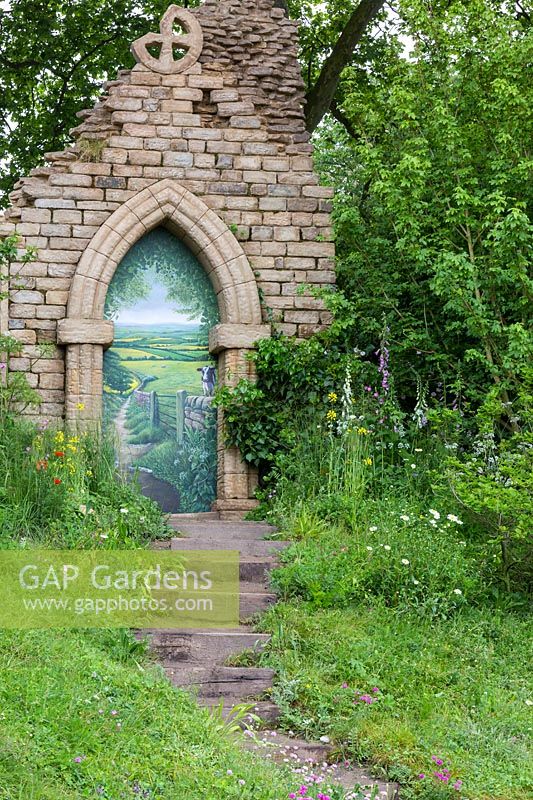 Welcome to Yorkshire, climbing pathway to ruined gothic archway with trompe d'oeil - RHS Chelsea Flower Show
