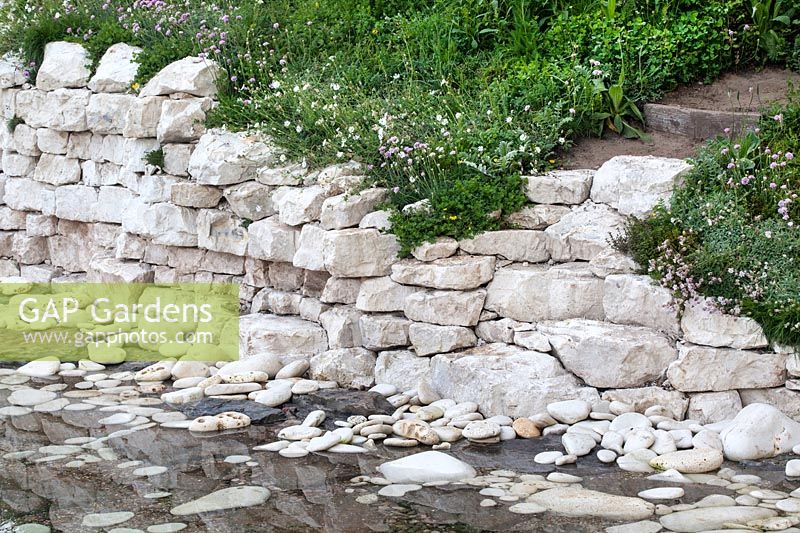 The Welcome to Yorkshire Garden - A view of the sandstone cliffs and the water, with sea thrift and many wild herbs and flowers - RHS Chelsea Flower Show 2017