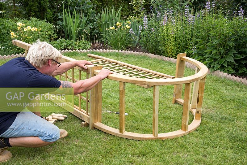 Making an Arch - Man fixing trellis sides to arch