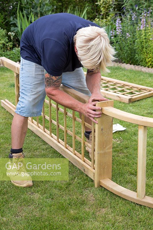 Making an Arch - Man fixing trellis sides to arch