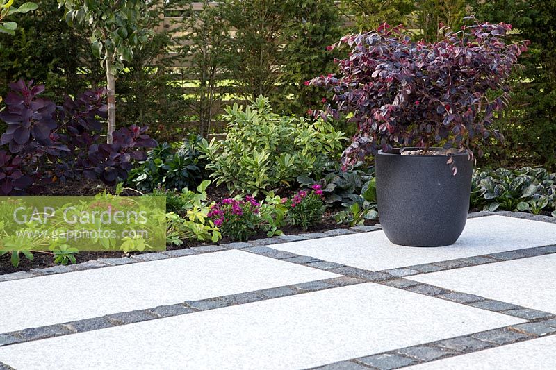 Making a mixed material patio - finished patio with mix of large porcelain slabs and small granite setts